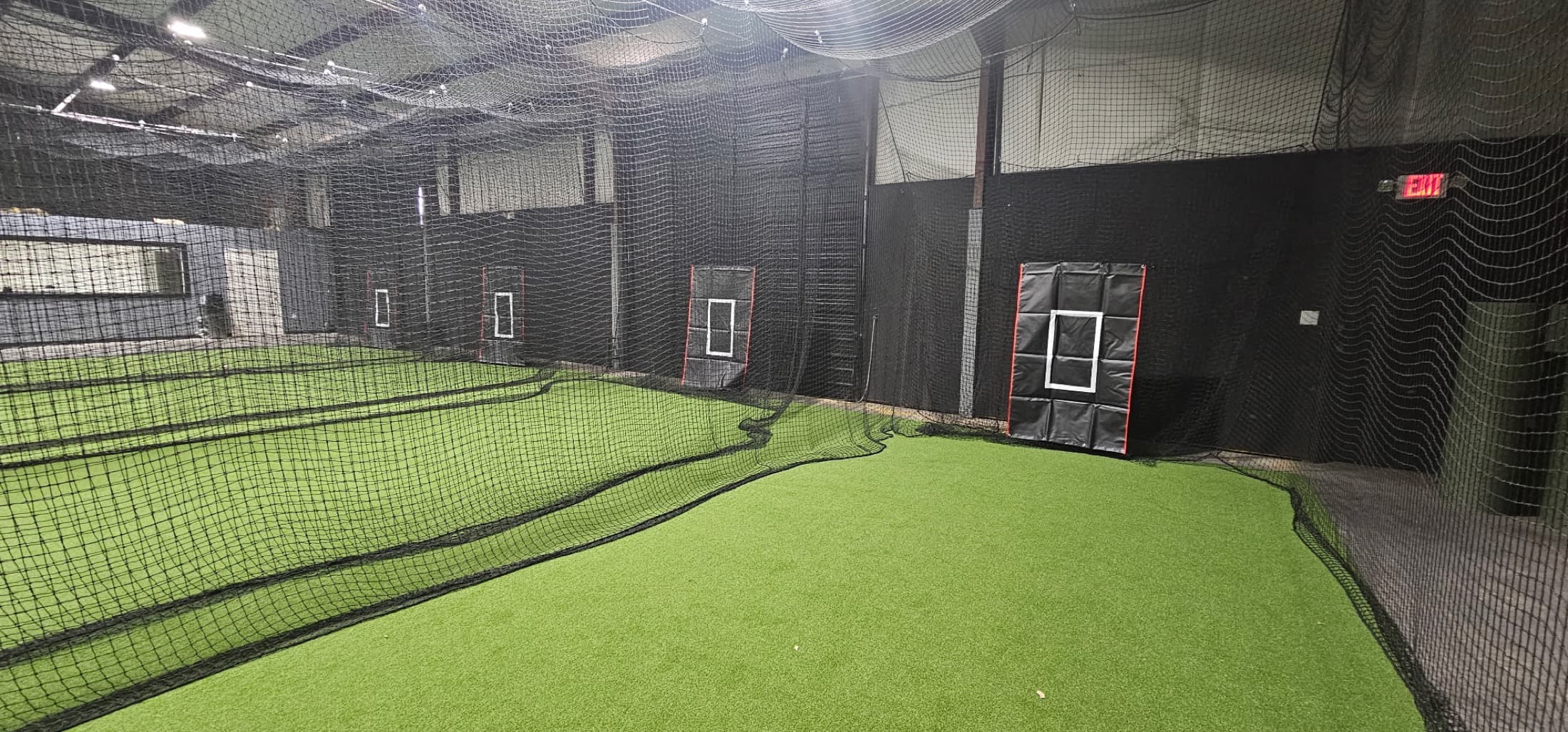 Indoor baseball training lanes at Momentum Sports in Houston